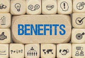Würfel mit Zahlen und Symbolen, die in der Mitte den Schriftzug Benefits tragen