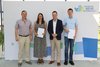 Vier Personen vor der Fotowand mit dem Logo "Frankens Mehrregion"