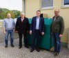 Vier Personen stehen vor dem Kühlbehälter